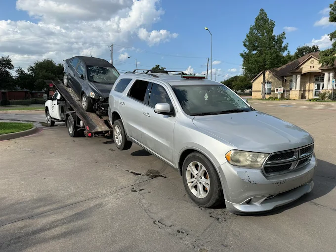 Clunqr Dallas team loading a junk vehicle for pickup